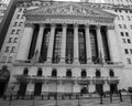 JUNE 7, 2018 - New York, New York, USA - New York Stock Exchange Exerior with US Flags - as seen through columns of Federal Hall Royalty Free Stock Photo