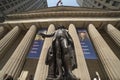 June 7, 2018 - New York, New York, USA - New York Stock Exchange Exerior with US Flags - as seen through columns of Federal Hall Royalty Free Stock Photo