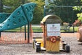 Plastic barriers to playground equipment with sign in English Spanish