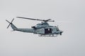 June 14, 2019 Pescadero / CA / USA - Marines Helicopter flying close to the Pacific Ocean coastline; cloudy sky background