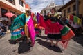 June 17, 2017 Pujili, Ecuador: indigenous women dancers in brigthly colored clothing performing on the street during Corpus Chris