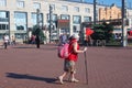 Woman with a backpack and sticks for walking walks on the platform Royalty Free Stock Photo