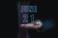 june 21st. Day 20 of month, announcement of date of business meeting or event. businessman holds the name of the month and day on