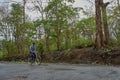 Student on bicycle in dandeli forest road at near yellapur karnataka india Asia