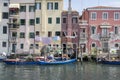 June 15, 2017 Sunny day in Chioggia, way of living in houses by the water, fishing housing in block of flats with fishing boats