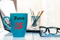 June 15th. Day 15 of month, color calendar on blue morning coffee cup at business workplace background. Summer concept