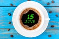 June 15th. Day 15 of month, everyday calendar written on morning coffee cup at blue wooden background. Summer concept