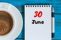June 30th. Image of june 30 , calendar on blue background with morning coffee cup. Summer day, Top view