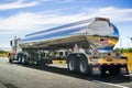 June 28, 2019 Tracy / CA / USA - Tanker truck driving on the freeway, the road and sky reflected in its shiny cistern Royalty Free Stock Photo