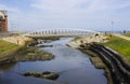 Visitors crossing the modern footbridge at the mouth of the Shimna River on the seafront in Newcastle County Down Northern Ireland