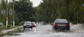 June 21, Vyshenky Ukraine. Consequences of the shower. Car splashes through a large puddle on a flooded street.