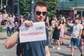 June 25, 2022 Warsaw, Poland - Equality parade in Warsaw, Poland. A man holding a piece of paper with the words - Stop