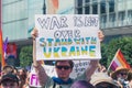 June 25, 2022 Warsaw, Poland - A person holds a placard saying War is not over. Stand with Ukraine during the