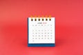 June 2024 white desk calendar on red background