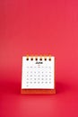 June 2024 white mini desk calendar on red background