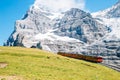 Jungfrau Eigergletscher snowy rocky mountain and red train in Switzerland Royalty Free Stock Photo