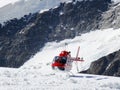 Jungfrau, Switzerlan. Red helicopter on high mountain snow