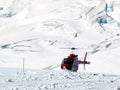 Jungfrau, Switzerlan. Red helicopter on high mountain snow