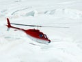 Jungfrau, Switzerlan. Red helicopter on high mountain snow