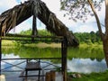 a jungle hut on a pond