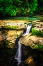 Jungle landscape with flowing turquoise water of georgian cascade waterfall at deep green forest. Mountain of georgia Royalty Free Stock Photo