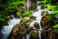 Jungle landscape with flowing turquoise water of georgian cascade waterfall at deep green forest. Mountain of georgia Royalty Free Stock Photo