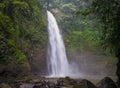 Jungle landscape with flowing turquoise water of waterfall at deep tropical rain forest. Royalty Free Stock Photo