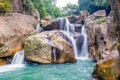 Jungle waterfall with flowing water, large rocks Royalty Free Stock Photo