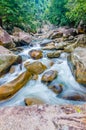 Jungle waterfall with flowing water, large rocks Royalty Free Stock Photo