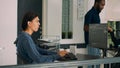 Junior developer writing database code to create new user interface on computer
