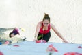 Junior female Athlete on climbing Wall and belaying referee