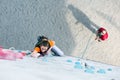 Junior female Athlete on climbing Wall and belaying referee