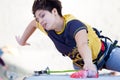 Junior female Athlete makes hard move on climbing Wall