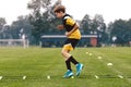 Junior football club player training on soccer ladder. Football training for sport team. Young boy running on agility ladder