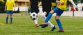 Junior Football Match. Boys Kicking Soccer Match on Grass Sports Field Royalty Free Stock Photo