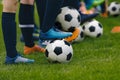 Junior Football Training Session. Players Standing in a Row with Classic Black and White Balls