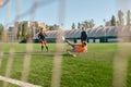 Junior forward jumping to kick ball with leg taking part in football match Royalty Free Stock Photo