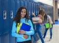 Junior High school Student standing by her locker in a school hallway Royalty Free Stock Photo