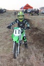 Junior motorbike rider posing on motorbike.