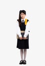 Junior school student in british international uniform standing carrying backpack and holding books posing full length Royalty Free Stock Photo