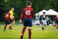 Junior Soccer Match. Football Game For Youth Players. Boys Playing Soccer Match on Football Pitch.