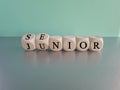 From junior to senior symbol. Turned cubes and changed the word \'junior\' to \'senior\'. Royalty Free Stock Photo