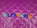 #learning learning hashtag on a purple background Royalty Free Stock Photo
