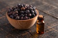 Juniper Berry Essential Oil on a Distressed Wooden Table Royalty Free Stock Photo