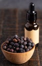 Juniper Berry Essential Oil on a Distressed Wooden Table Royalty Free Stock Photo