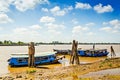 Junk boats docked on wooden struts on a river in the Mekong Delta in Vietnam. (Ho Chi Minh City, Vietnam - 2/01/2020