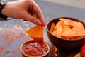 Junk fast food eating nacho chips tomato sauce dip Royalty Free Stock Photo