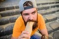 Junk food. Carefree hipster eat junk food while sit stairs. Guy eating hot dog. Snack for good mood. Unleashed appetite Royalty Free Stock Photo