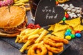 Junk food concept. Unhealthy food background. Fast food and sugar. Burger, sweets, chips, chocolate, donuts, soda