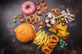 Junk food concept. Unhealthy food background. Fast food and sugar. Burger, sweets, chips, chocolate, donuts, soda, top view Royalty Free Stock Photo